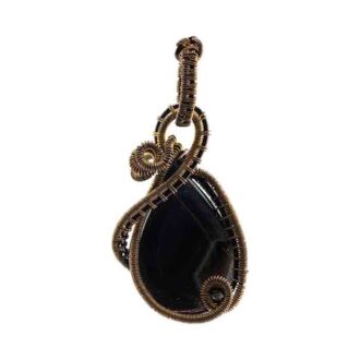 Teardrop shaped stone wirewrapped as a pendant in an intricate design
