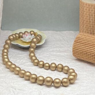 Handmade bead necklace in antique gold. Bead size is graded.