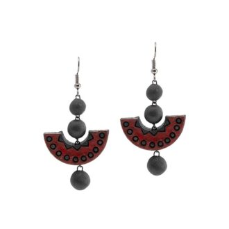 Handmade terracotta earrings in red and black accents. Has a semicircle engraved design and beads